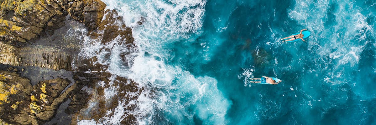 two people surfing