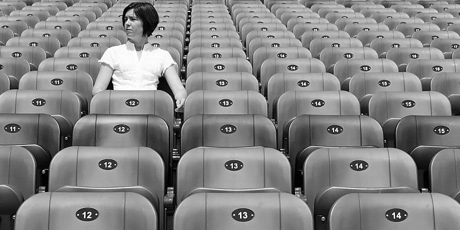 photo women sitting in stadium alone